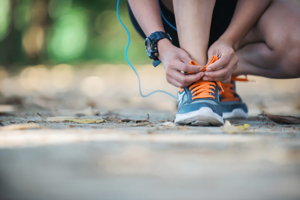 Discover the 10 Healthy Habits of Fit People 2 Young fitness woman sitting tie their shoes before she go joggin
