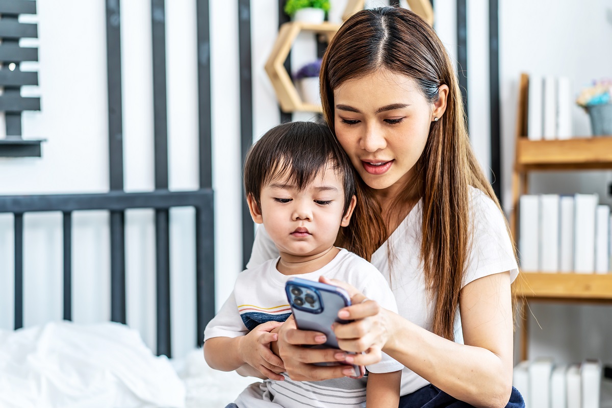 Mother and child using phone