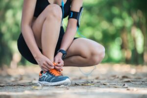 Woman tying running shoes