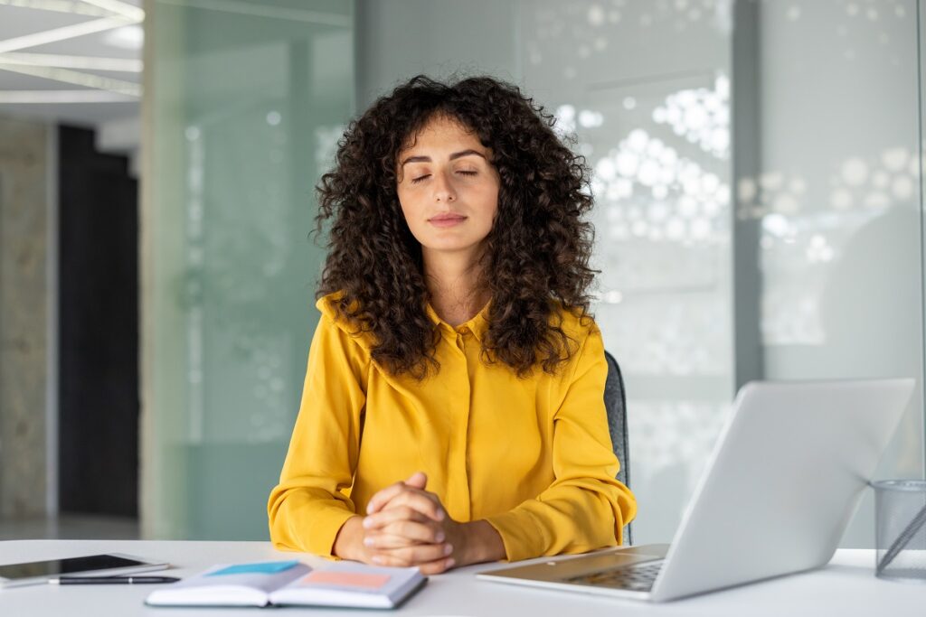 Declutter Your Mind for Inner Peace and Focus 2 Woman meditating at desk