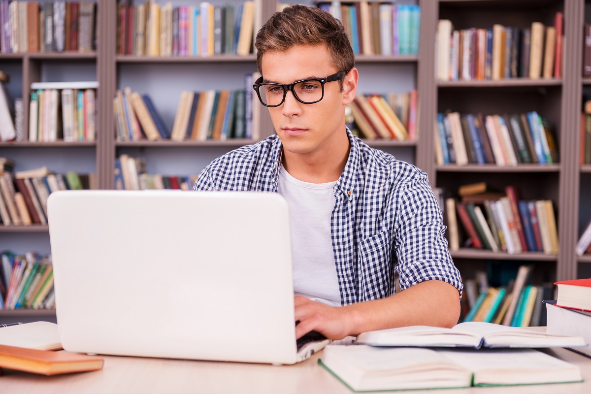 Man working on laptop in library