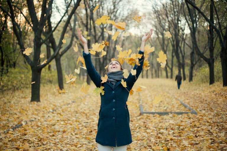 Woman joyful in autumn park