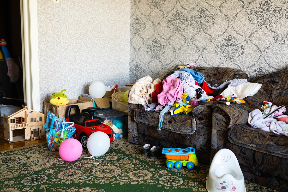 Cluttered living room with toys and clothes