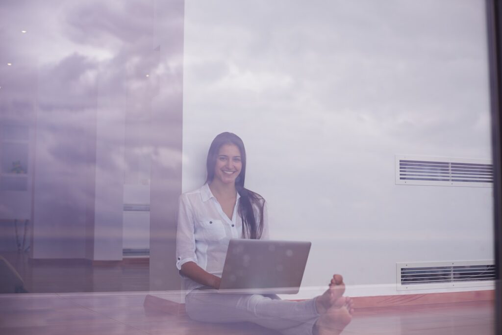 Woman working on a laptop indoors.