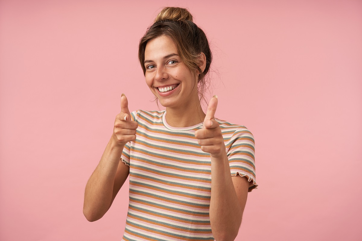 Smiling woman pointing confidently