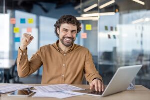 Man celebrating success at work