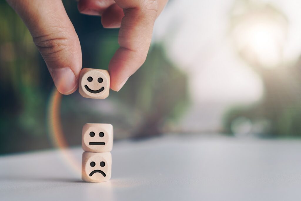 Hand stacking emotional face blocks