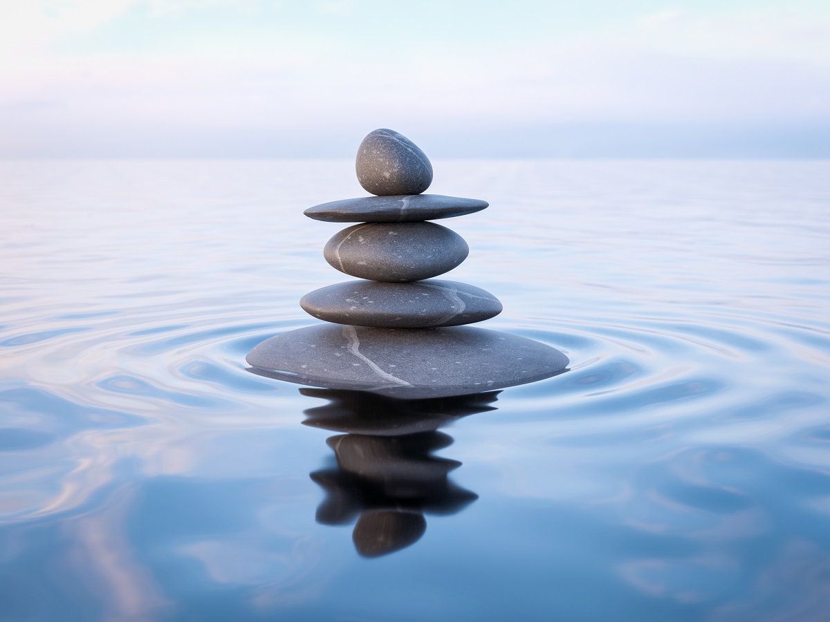 Balanced stones on calm water